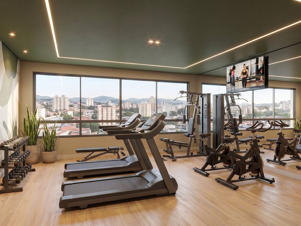 Academia com esteiras e bicicletas de frente para a janela