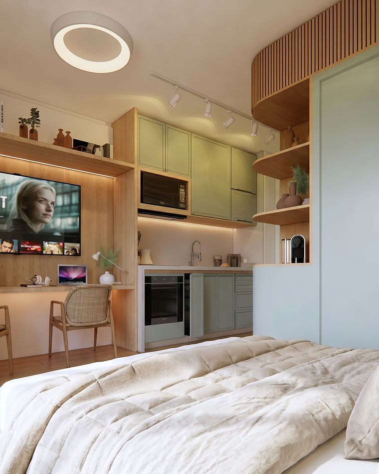 Studio em verde-claro com mesa de trabalho e cozinha
