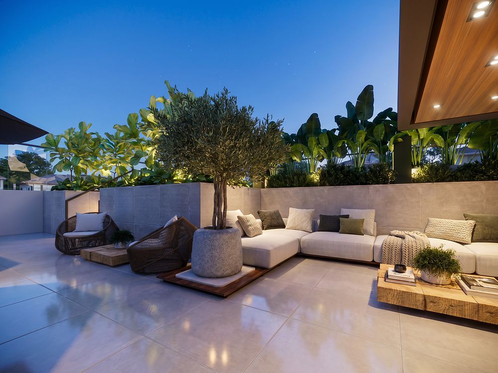 Lounge ao ar livre com sofás e uma oliveira